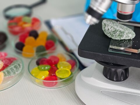 Sugar candy analysis under a microscope in a lab setting during a science experiment concept