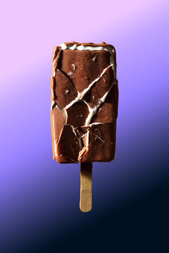 Cracked Chocolate Ice Cream Bar on Wooden Stick with Purple Gradient Background