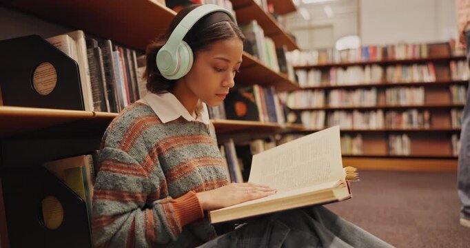 Music, headphones or girl in library reading book at university, college or school campus for education. Relax, learning or smart student with scholarship studying knowledge, research and information