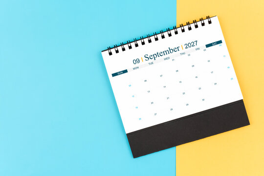 September 2027 desk calendar on blue and yellow, planning for business meeting or planning concept.