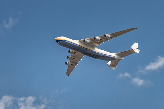 Large cargo aircraft flying in clear blue sky