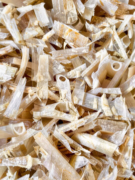 Shredded bio plastic particles vertical close up texture background