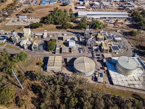 Aerial view of the Yabulu Power Station featuring large industrial storage tanks, processing facilities, and surrounding vegetation in Yabulu, Queensland, Australia.