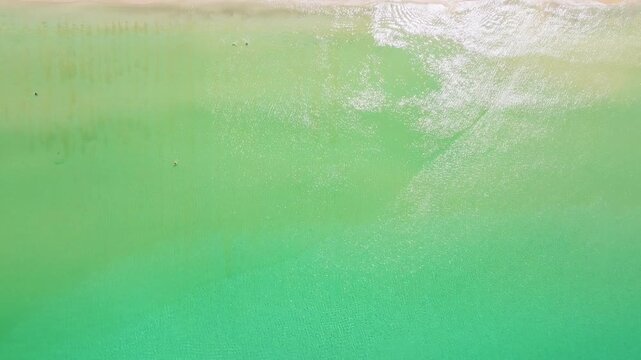 Beautiful sea summer landscape, Waves sea water surface High quality video Bird's eye view, Drone top view waves crashing on sand beach,Nature ocean sea beach background