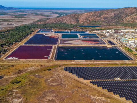 Aerial view of Sun Metals Corporation Pty Ltd zinc refinery featuring large industrial ponds and an extensive solar farm in Stuart, Queensland, Australia.