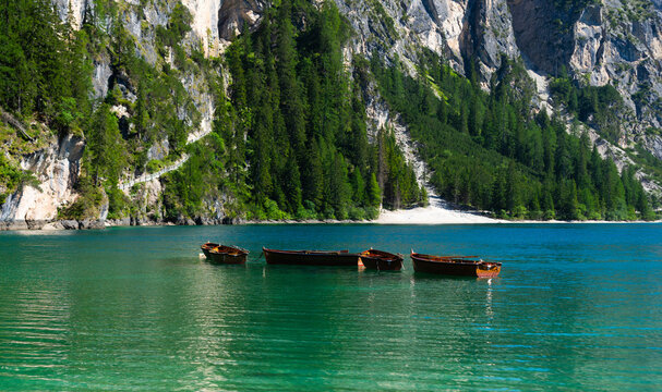 Boats on the Braies Lake in Dolomites mountains, Italy