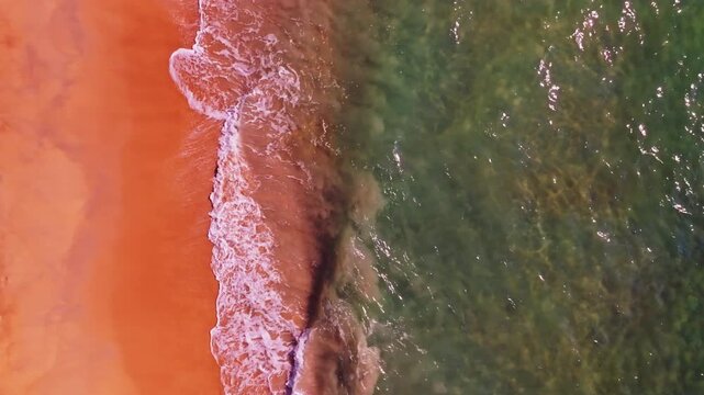 Beautiful sea summer landscape, Waves sea water surface High quality video Bird's eye view, Drone top view waves crashing on sand beach,Nature ocean sea beach background