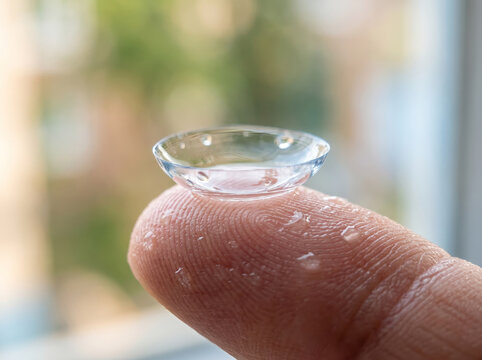 Flexible Contact Lens Resting On Fingertip Close Up