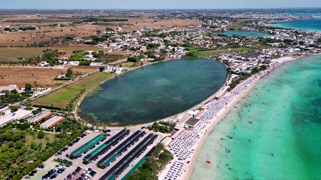 Aerial view of Spunnulata di Torre Lapillo beach and natural water basin on the coast of Porto Cesareo, Salento, Puglia, Italy