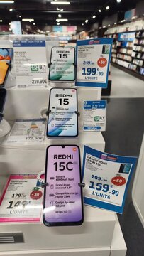 Royan, France - August 06, 2026: Charente-Maritime. Nouvelle-Aquitaine. Display of Xiaomi Redmi 15 and 15C smartphones with pricing labels in electronics store interior