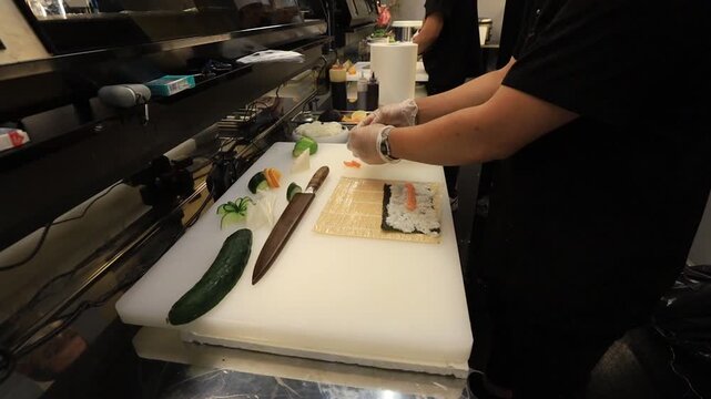 The chef prepares sushi dishes