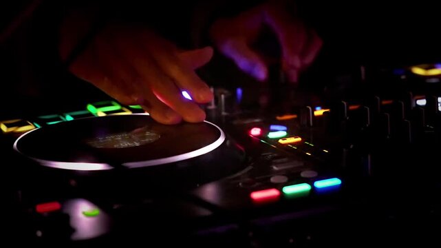 Close-Up of a DJ Mixing Music with Dynamic Club Lighting and Vibrant Effects