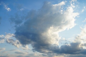 Obraz premium Clouds floating, in sky, with clouds, from a aerial perspective, with blue, white accents, and serene expansive mood, with nearby objects, in surrounding setting.