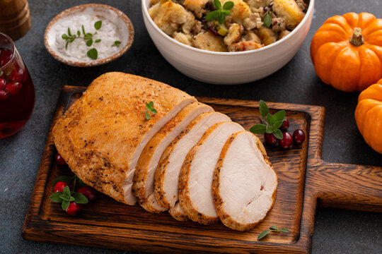 Roasted turkey breast sliced on a cutting board
