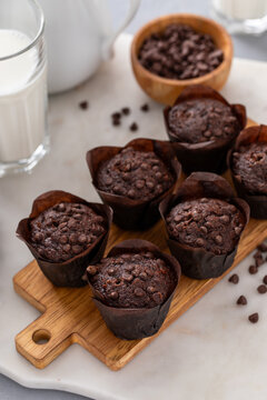 Chocolate chip muffins mini size on a board served with milk, double chocolate muffins, dessert idea