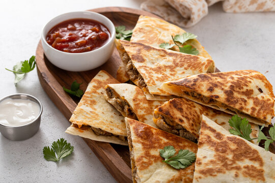 Ground beef and cheese quesadillas on a serving plate
