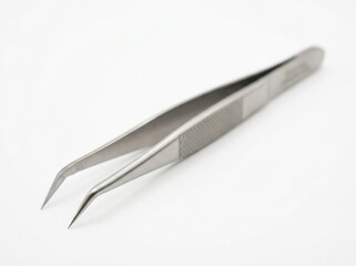 Fototapeta premium Close up of stainless steel curved precision tweezers isolated on white background