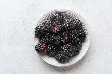 blackberries on a plate on a light background © JuliaLavleis