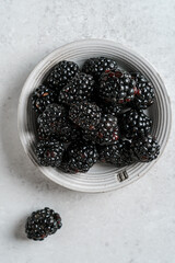 a bucket of blackberries on light background © JuliaLavleis