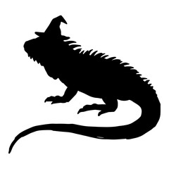 Obraz premium Silhouette of iguana wearing a witch hat for halloween celebration.