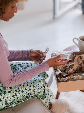 Woman looking at damaged glass after delivery 
