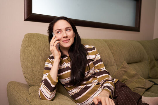 Talking on the phone while relaxing at home in the evening