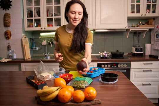 Woman preparing food in kitchen during daytime