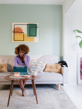 Woman talking on the phone while using tablet computer 