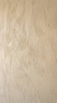 Close up of textured plaster wall surface showing natural variations with interior