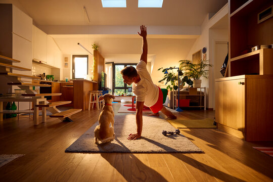 Active man exercises yoga in the morning