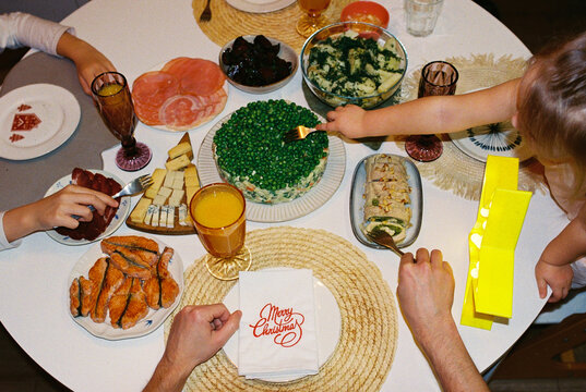 Family while festive Christmas dinner with children.