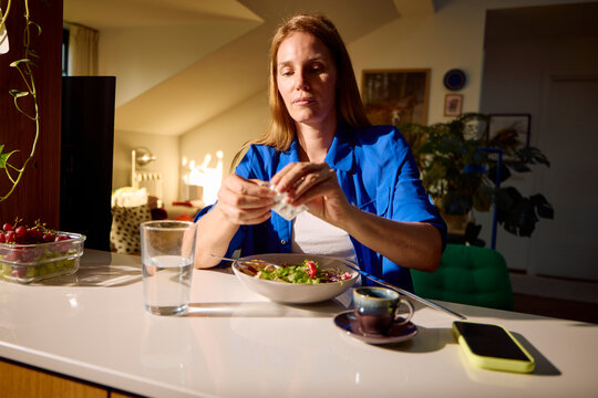 Woman grabs the afternoon meal at home