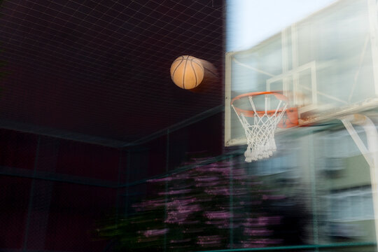 A basketball is flying toward the hoop.
