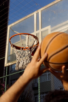 man throwing a basketball into a hoop