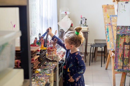 Child in art school works with paints