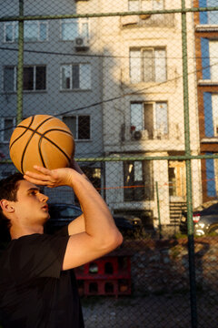 man throwing a basketball into a hoop