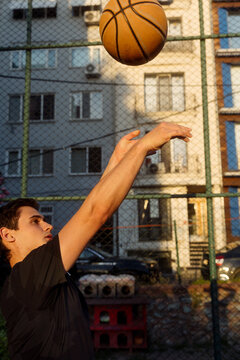 man throwing a basketball into a hoop