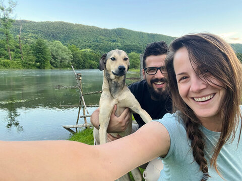 Friends Take a Selfie With Dog by the River in Nature