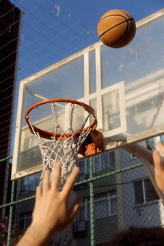 man throwing a basketball into a hoop
