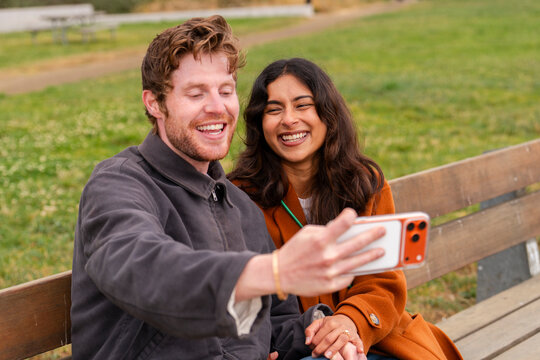 couple using cellphone together 