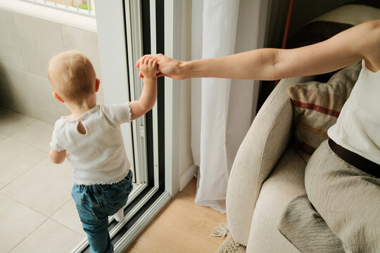 Overhead photo of anonymous little child holding mother&rsquo;s hand
