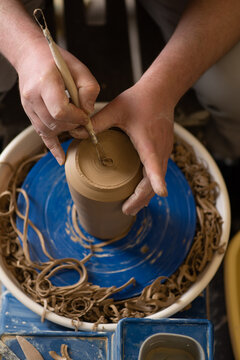Male hands working with clay on a potter's wheel