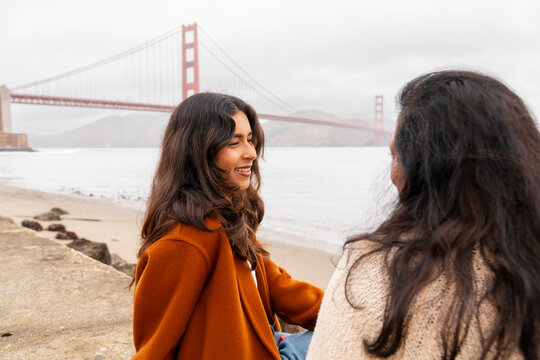 Friends Relax by Beach Near Golden Gate Bridge