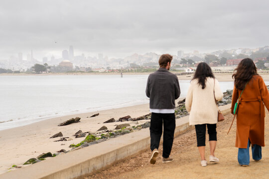 friends exploring walking together promenade water san francisco city