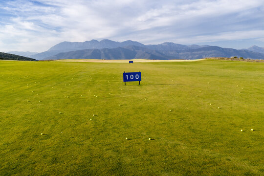 Golf course With Distance Markers and Mountains in the Background