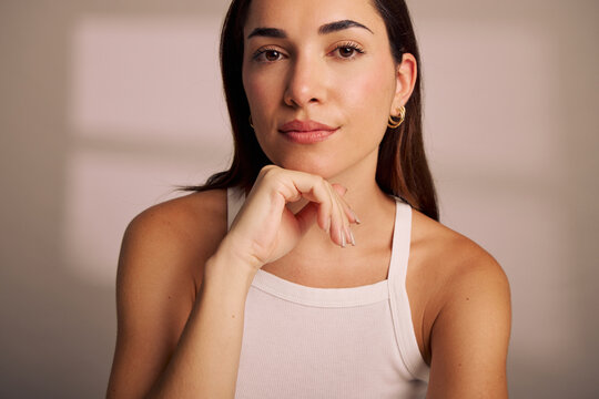 Young Woman Poses Thoughtfully in a Simple Indoor Setting