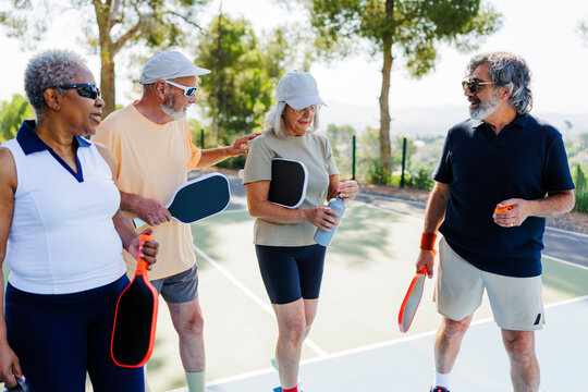 Seniors friends enjoying pickleball game 