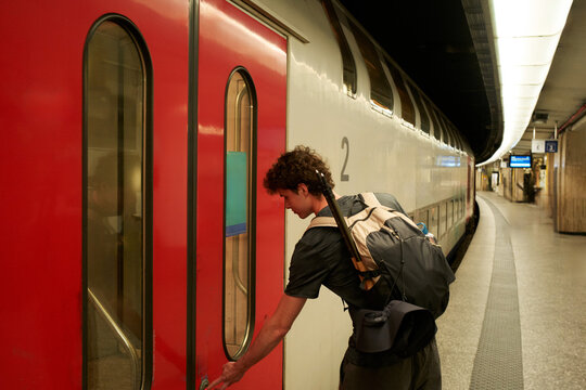 Man Boards Train at Subway Station in City During Evening