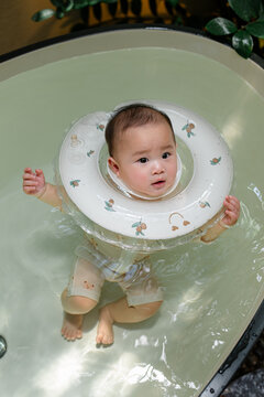 Adorable baby floats safely in bathtub with neck float