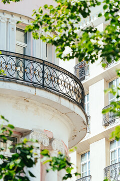 Historic balcony view surrounded by green leaves in a city